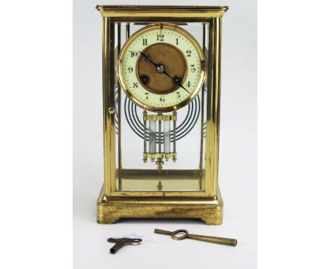 A lacquered brass four-glass mantel clock of rectangular outline, the circular movement with 9cm Arabic dial, the backplate s