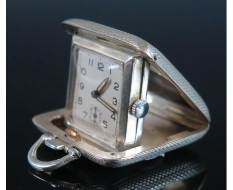 A George V silver cased travelling timepiece, maker SSM, Birmingham, 1935, with 2.25cm Arabic dial with subsidiary seconds di