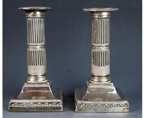 A pair of Victorian silver candlesticks maker Henry Wilkinson &amp; Co, London, 1886, with plain sconces on stop fluted colum