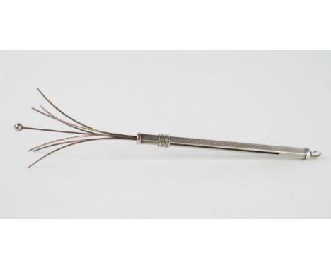 A silver cocktail swizzle stick, stamped 925, with engine turned decoration, 13.5cm extended. 