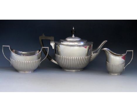A matched three-piece tea service, various makers and dates, of oval outline with half reeded decoration, total weight of sil