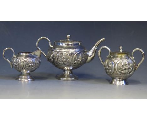 An Indian silver miniature silver three-piece tea service, includes pedestal teapot, cream jug, sugar basin and lid, total we