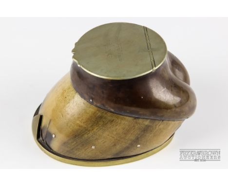 A white metal and brass mounted horse's hoof, the hinged lid engraved 'One of the Best, Peacock', opening to reveal an inkwel