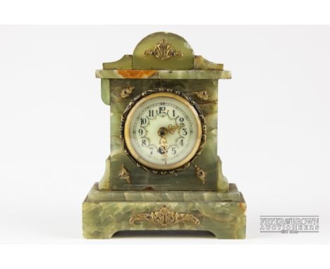 A small onyx ormolu mounted clock, enamel dial with Roman numerals