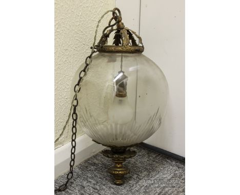 An early 20th century hanging light fitting, cut lines radiating from base, with brass detailing