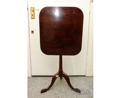 A mahogany tilt-top table, the rectangular top with canted corners, on curved tripod legs, 68.5cm high
