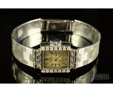 A vintage Baume &amp; Mercier 18ct white gold and diamond ladies wristwatch, case numbered 342263/3822, on a textured chequer