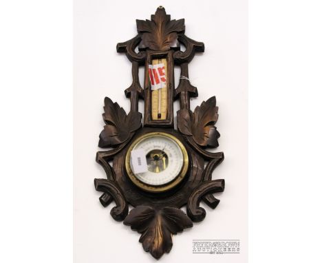 A small barometer/thermometer, in foliate carved mount 