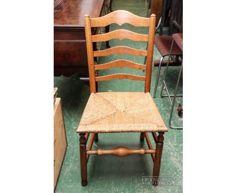 A light oak single dining chair with rush seat