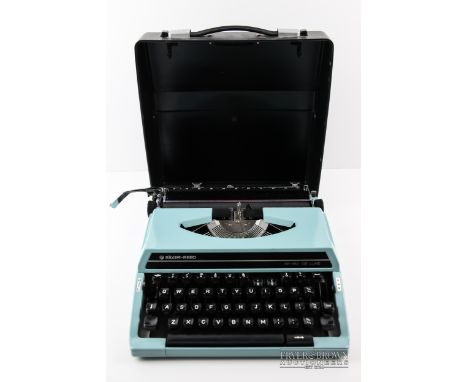 A silver Reed SR180 Deluxe portable typewriter, in case 