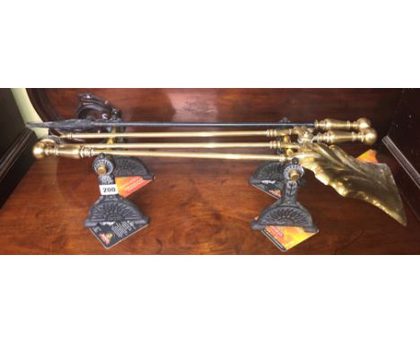 BRASS FIRE TOOLS ON BLACKENED ANDIRONS AND BRASS FINIAL FIRE CURB