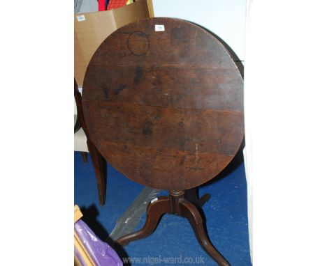 A 30" diameter tilt top table on tripod foot.