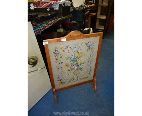 A light oak framed floral tapestry firescreen.