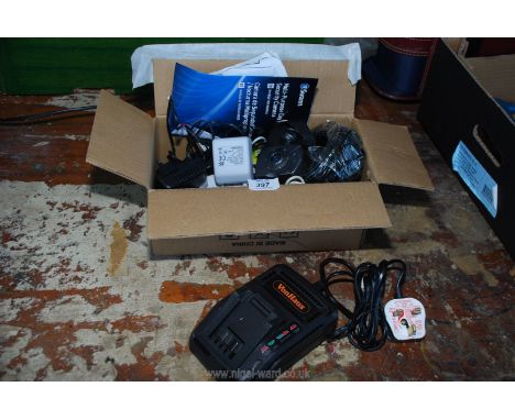 A security camera with accessories and a 21 volt Von Haus tool charger.