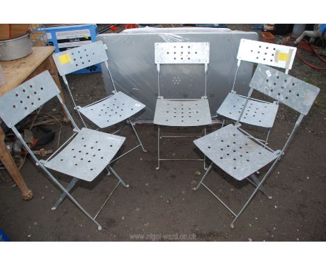 Five chairs and a table.