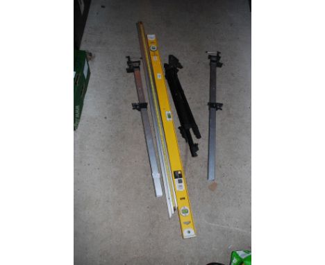 A pair of 32" sash clamps, a camera tripod, a builder's level and a rule.