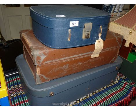 Three vintage suitcases; two blue and one brown.