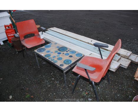 Two plastic chairs and a metal framed coffee table