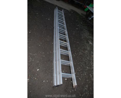 An aluminium 11 rung triple ladder.