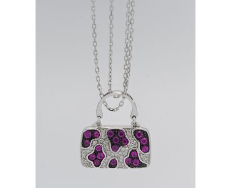 Iliana- an 18k white gold ruby and diamond pendant in the form of a bag, approx. 9.6g, with receipt.