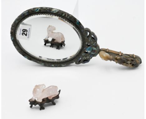 A carved jade belt hook, Qing dynasty, carved in the form of a horse’s head facing bats on a fruiting vine, the stone with ce