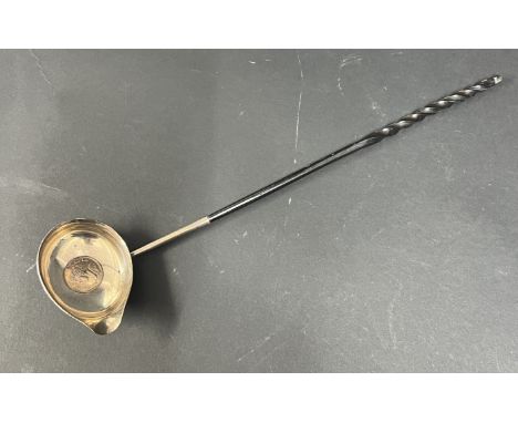 A silver punch ladle, with Queen Anne silver coin 1711 set in base with a whale bone handle.
