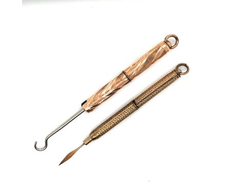 A gold-plated screw-down toothpick and a similar button hook. 