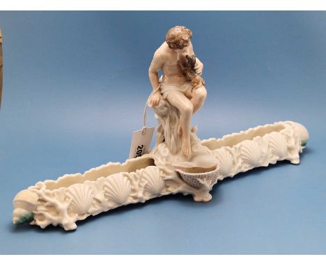 A Royal Worcester glazed parian centrepiece, the central figure of a man seated with his dog on his lap above a posy trough w