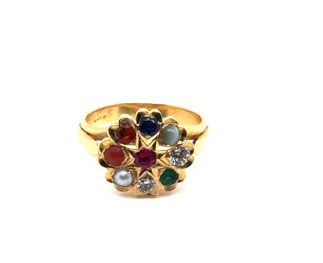 A late 20th-century mixed gem-set cluster ring. The nine stones a combination of ruby, emerald, white sapphire, cat's eye chr