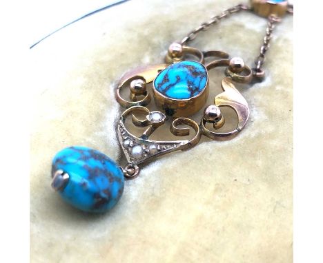 An antique turquoise and seed pearl pendant necklace. The pendant is marked 9ct to the reverse and the chain has a 9ct tag ne