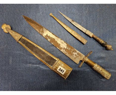 An Argentinian hunting knife and metal mounted leather scabbard together with a smaller knife, the scabbard with a fish clasp