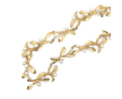 A Metropolitan Museum Of Art MMA 14k 585 yellow gold and rice pearl necklace with leaf motif. Length 45 cm. Weight 21.6 grams