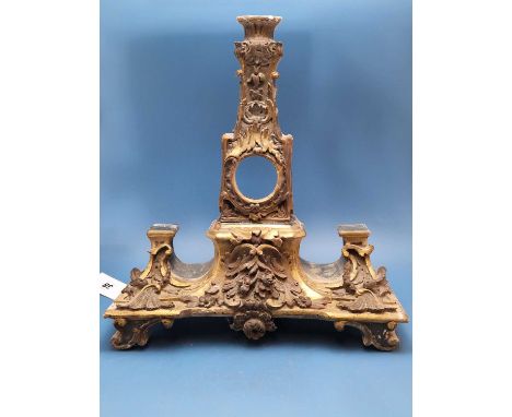 A parcel gilt carved wood wall bracket, central flowers below the shelf flanked by foliate buttresses and above a square sect