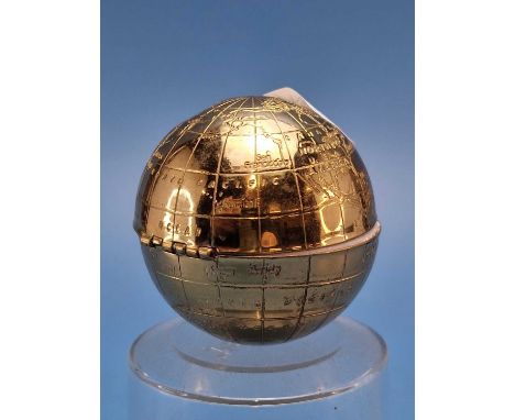 A gilt metal terrestrial globe powder compact.   Dia 5.5cms.