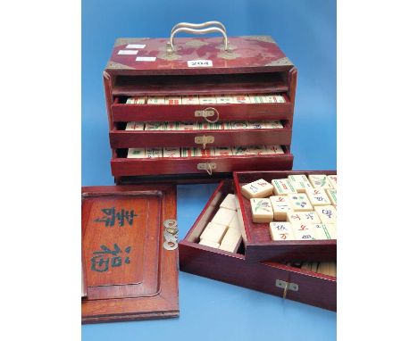 A wooden cased bone and bamboo mahjong set