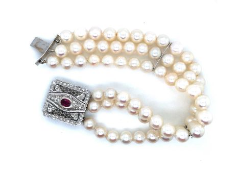 A three-row cultured pearl bracelet complete with a ruby and diamond set clasp. Pearl average measurements 6.7. The clasp unh