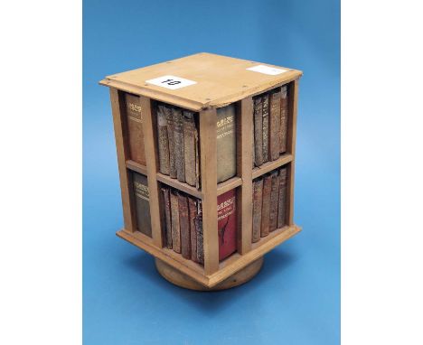 A miniature rotary bookcase filled with leather bound volumes of Shakespeare's plays.   H 18cms