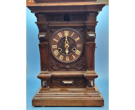 A mahogany cased fusee driven cuckoo clock, the dial with white Roman numerals and cut work hands, the case. H 44cms