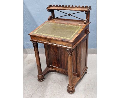 A 19th century calamander wood davenport, the open shelf back behind a leather inset sloping lid, a door to one side below ov