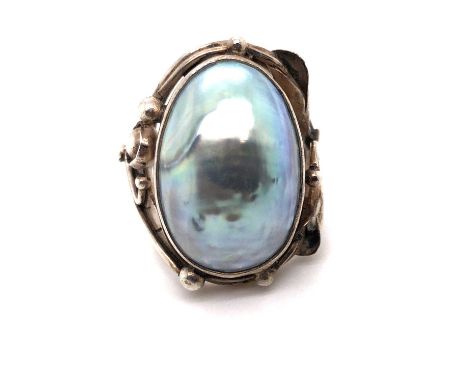 A grey mabe pearl Art Nouveau-style ring. The closed back setting marked 925, assessed as silver. Ring size N. Weight 11.5 gr