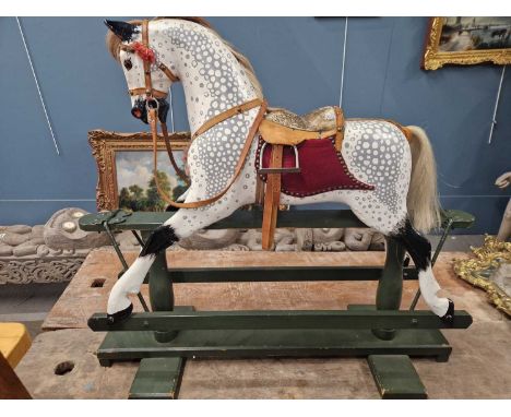 An early 20th-century tressle base hand painted dapple rocking horse.