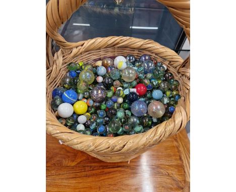 An extensive collection of Vintage and later Glass marbles contained in a wicker shopping basket.