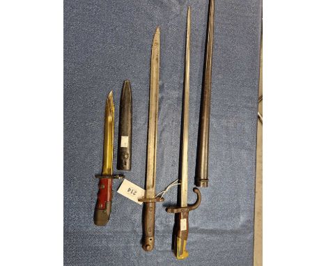 A French 1879 pattern bayonet with a metal scabbard, a French 1907 pattern bayonet together with a modern War Dept bayonet wi