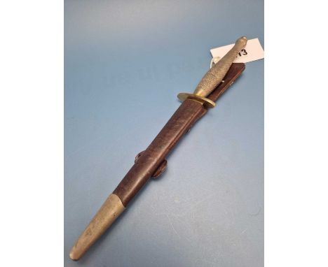 A Fairbairn-Sykes fighting knife with a diced metal handle and in a leather scabbard