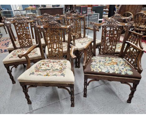 A set of ten Chinese Chippendale style mahogany dining chairs to include four with arms and with a spare needlework seat cove