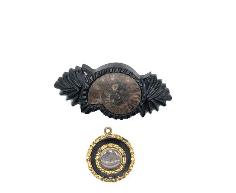 An antique mourning pendant with a glazed hairwork panel front with monogram engraving to the reverse, together with an ammon