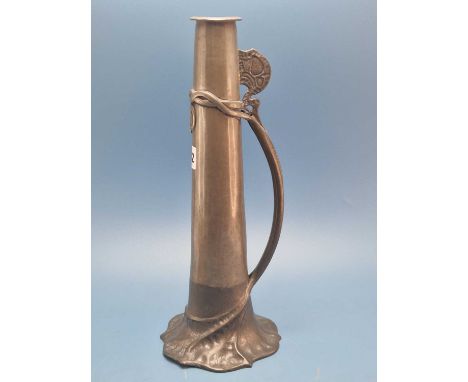 David Veasey for Liberty's, a Tudric pewter ewer, the cylindrical shape flaring to a foliate foot with the stem handle attach