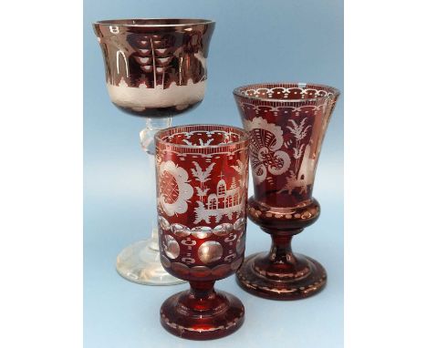 A Bohemian ruby glass overlay goblet, the bowl engraved with a stag.   H 22.5cms. a thistle shaped vase engraved with shells 