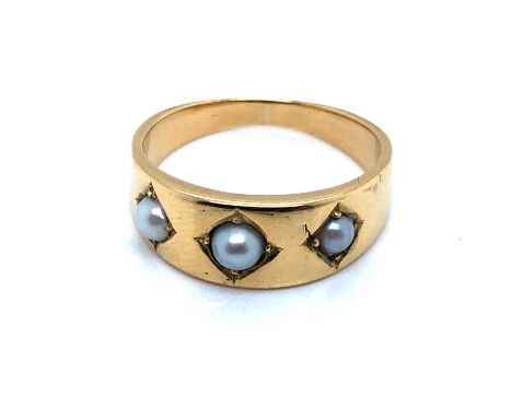 A vintage three-stone cultured pearl gypsy set ring. Unhallmarked, assessed as 18ct gold. Ring size M. Weight 4.7 grams.