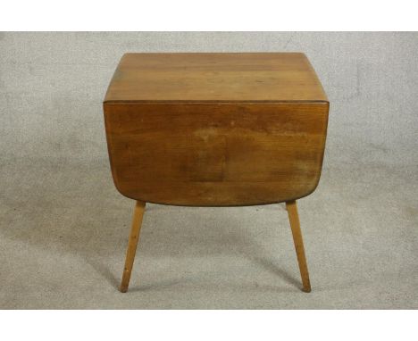 An Ercol light elm drop leaf dining table, with two drop leaves on splayed beech legs. H.72 W.137(ext) D.74cm. 